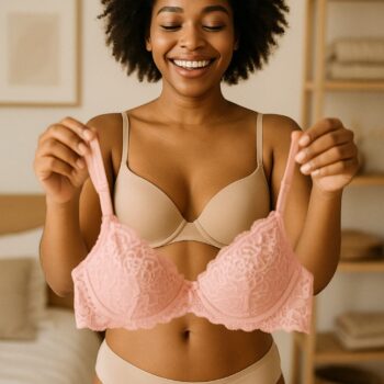 Woman admiring herself in the mirror while wearing a simple, elegant bralette.