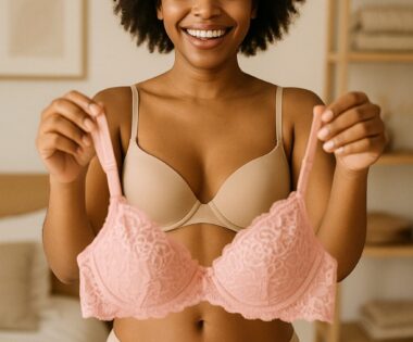 Woman admiring herself in the mirror while wearing a simple, elegant bralette.