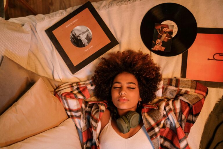 A relaxed Black woman lying on a bed surrounded by vinyl records, enjoying a moment of nostalgia and peace